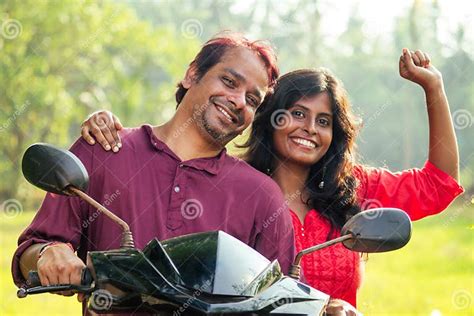 Happy Indian Married Couple Riding On Motorbike In Tropical Jungle In