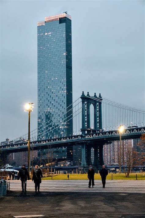 People Walking In Brooklyn Park With Manhattan Bridge In The Background