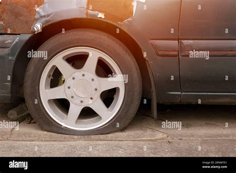 Car With Flat Tire Parking Outdoor In Hot Weather Damaged Old Broken Vehicle Need To Service