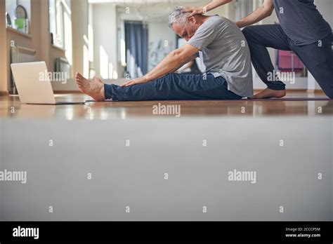 Caucasian Man Doing A Seated Forward Bend Stock Photo Alamy