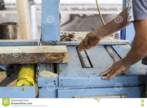 Craftsmen Cut A Piece Of Wood At A Woodworking Factory In Greece Stock