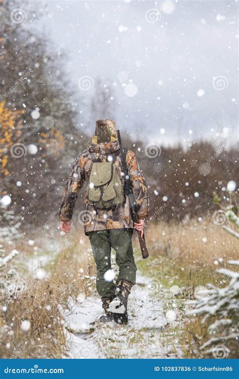 Male Hunter With Backpack Armed With A Rifle Stock Photo Image Of