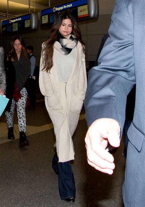 Flared Jeans And An Oversize Cardigan Selena Gomez Airport Style