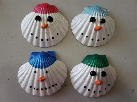 Four Snowmen Made Out Of Seashells On A Table