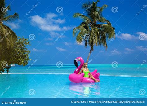 Beautiful Tanned Woman Bikini Model On Pink Flamingo In Pool Young Glamour Girl In Swimsuit On