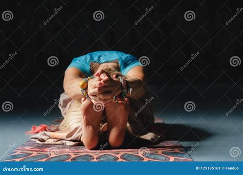 Beautiful Mature Blond Woman Making Yoga Indoors Alone In Colorful