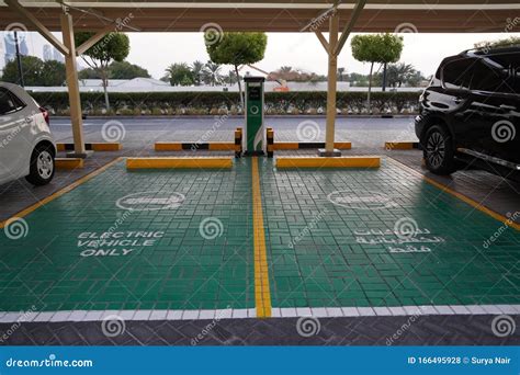 Green Electric Vehicle Charging Station Sign In A Parking Bay Electric