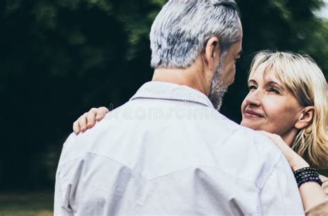 Lovely Senior Elderly Smiling Couple Man And Woman With Happy Hug Or