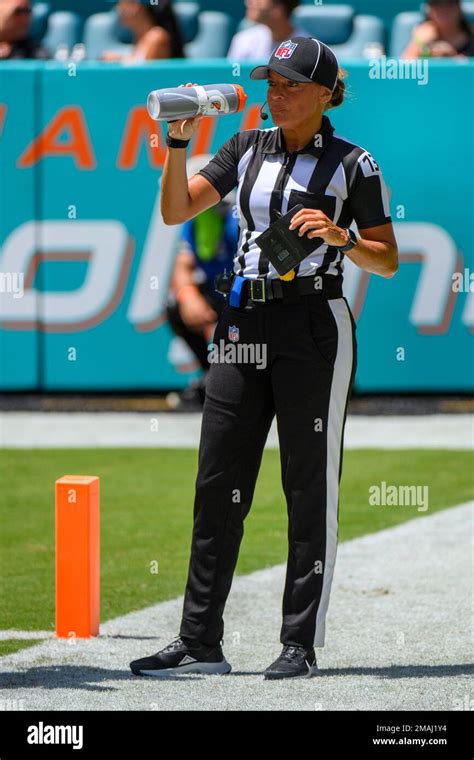 NFL down judge Robin DeLorenzo drinks water on the field during an NFL ...