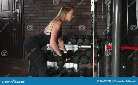 Adult Woman Performs One Arm Bent Over Dumbbell Row Exercise Stock