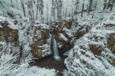 Premium Photo | Waterfall in snowy mountains during the winter