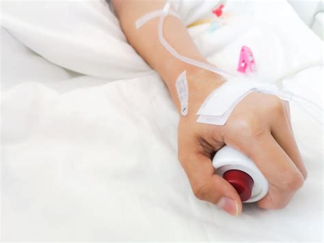 Premium Photo Cropped Hand Of Patient With Iv Drip On Bed At Hospital