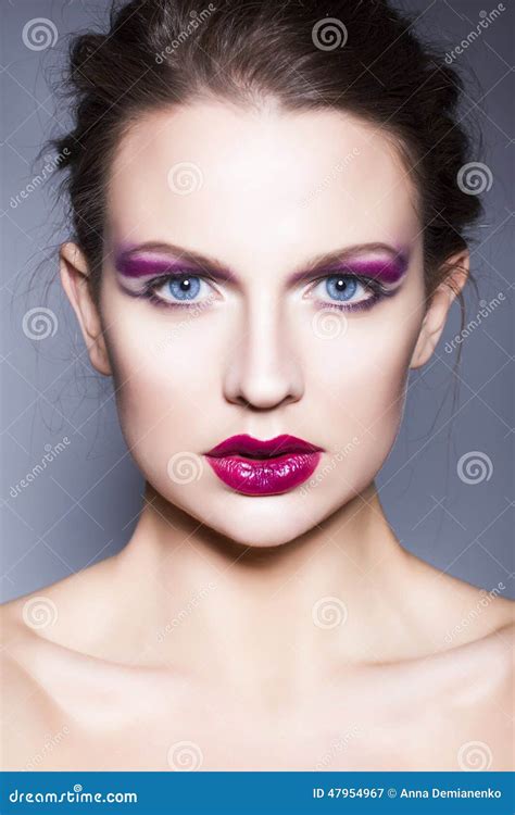 Brunette Woman With Creative Make Up Violet Eye Shadows Full Red Lips Blue Eyes And Curly Hair