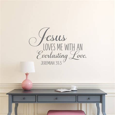 A Desk With A Lamp And A Wall Decal That Says Jesus Loves Me With An Everlasting Love