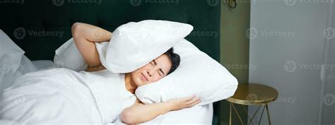 Insomnia Asian Girl Shuts Her Ears With Pillow As Partner Snoring Woman Lying In Bed Bothered