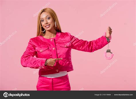 Smiling Trendy African American Woman Pointing Finger Handcuffed Hand