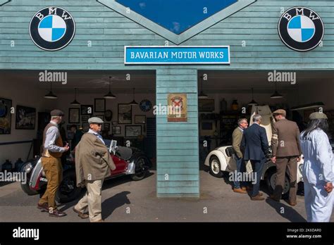 People Dressed In Vintage Period Clothes Looking At Frazer Nash Bmw