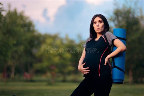 Pregnant Woman Feeling Contractions After Exercising Stock Image