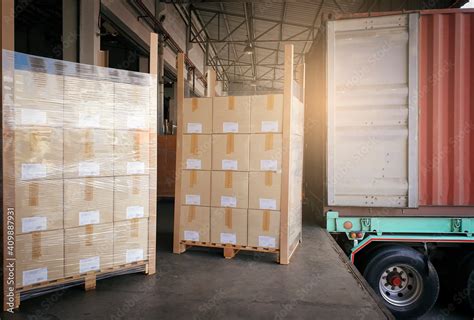 Stacked Of Cardboard Boxes Wrapped Plastic On Pallet Waiting To Load