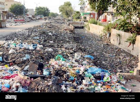 Heap Of Garbage Covered Sewerage Drain Causing Blockage Of Sewerage