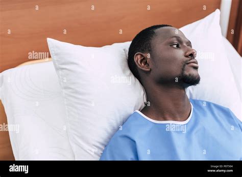 Portrait Of Pensive African American Man Looking Away While Lying In