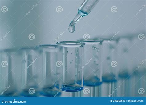 Dripping Liquid From Pipette Into Test Tube In Laboratory Light Airy