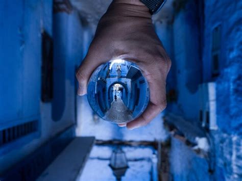 Premium Photo Cropped Hand Of Person Holding Crystal Ball In Alley