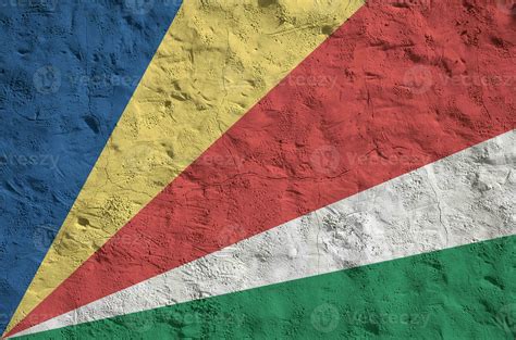 Seychelles Flag Depicted In Bright Paint Colors On Old Relief