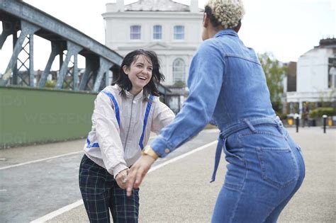 Happy Lesbian Friends Having Fun On Bridge Stock Photo