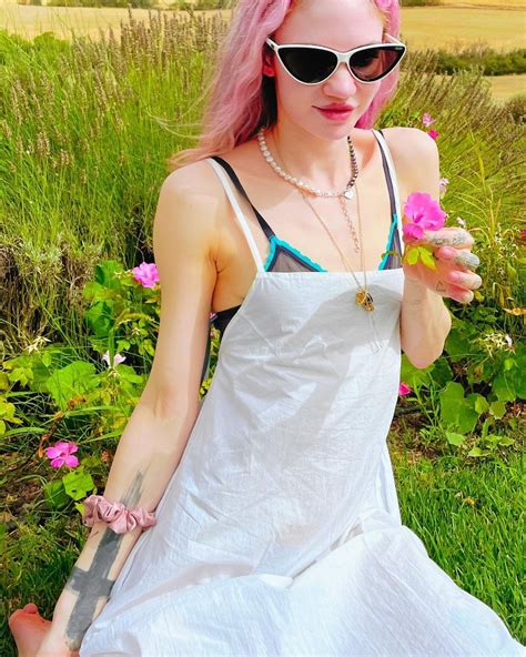 Grimes Poses With Flower Entertainment News Gaga Daily