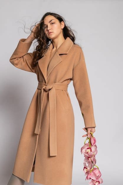 Premium Photo Seductive Blonde Woman In Brown Jacket Posing In Studio On Grey Background