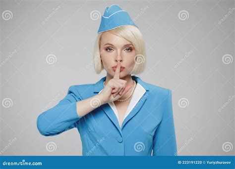Attractive Blonde Flight Attendant Encourages Silence Stock Photo Image Of Attractive