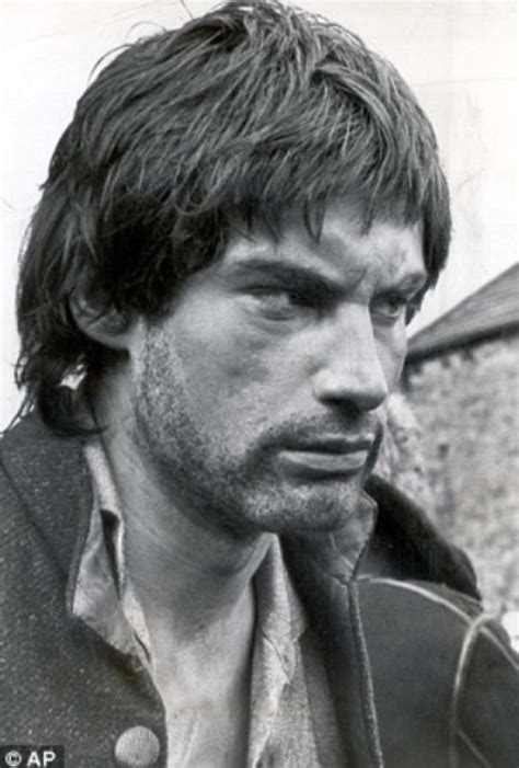 Black And White Photograph Of A Man With Long Hair Wearing A Jacket