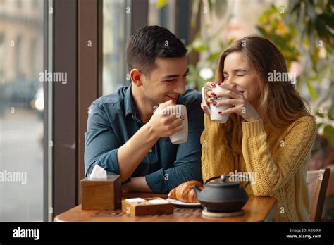 Young Attractive Couple On Date In Coffee Shop In Love Man And Woman