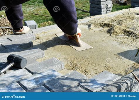 Construction Worker Are Laying Concrete Pavement Stone For Footpath