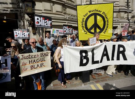 Protesters Hold Placards Outside The Queen Elizabeth Ii Conference