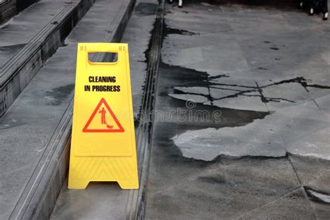 Yellow Caution Cleaning Progress Sign On The Floor Outdoors Stock Image