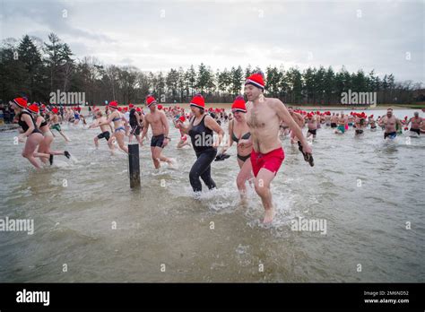 OLDENZAAL, NETHERLANDS - JANUARY 1, 2023: People running into the water ...