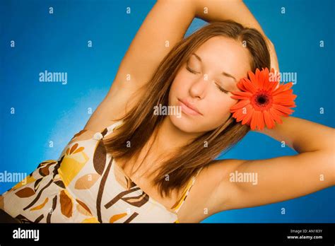 Brunette Model With Flower In Her Hair Stock Photo Alamy