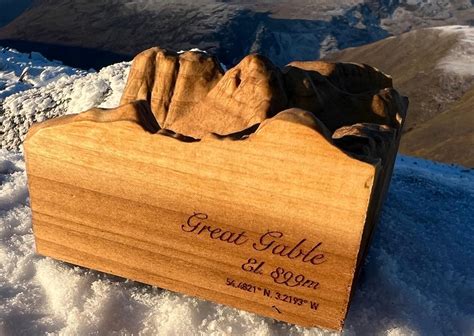 Miniature Mountain Sculptures Left To Be Discovered Across Lake
