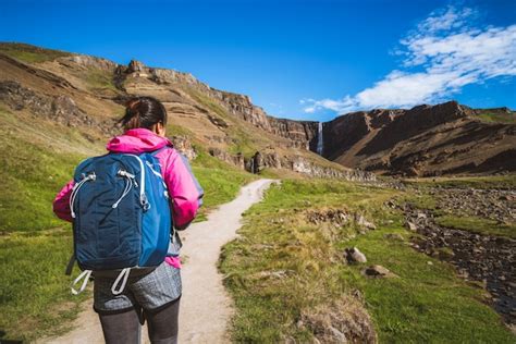 Premium Photo | Traveler hiking at hengifoss waterfall, iceland.