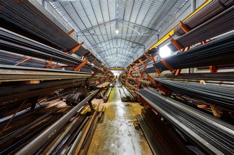 Aisle Between Racks With Rolled Metal Products In Store Stock Photo