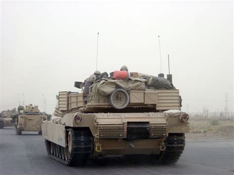 A Convoy Of US Army USA M1A1 Abrams Main Battle Tanks MBT And M2A2