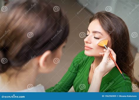 Make Up Artist Applying Professional Make Up Of Tonal Foundation Stock