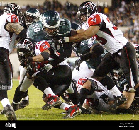 Atlanta Falcons Running Back Warrick Dunn 28 Gets Tackled By Philadelphia Eagles Defender