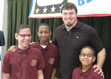 New York Giants player Chase Blackburn with students from The Leake