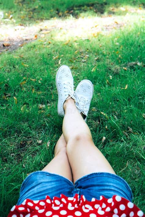 Slender Female Naked Tanned Legs Top View On The Green Grass Stock