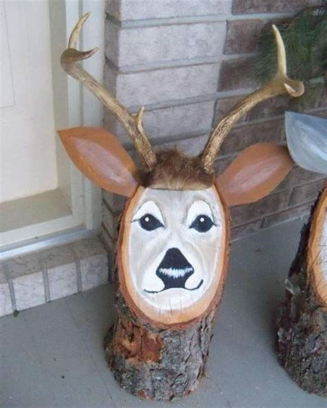 Two Carved Deer Heads Sitting Next To Each Other On Top Of Tree Stumps