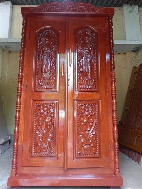 Two Wooden Doors With Carvings On Them