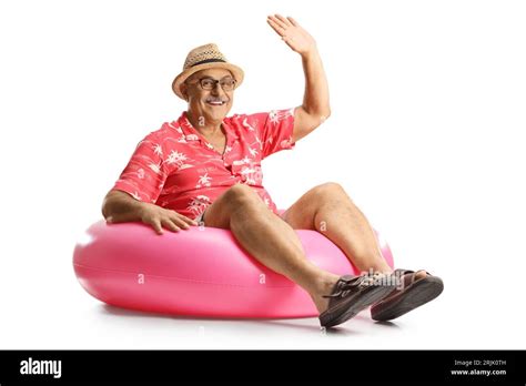 Mature Man Sitting On A Big Inflatable Rubber Ring And Waving Isolated